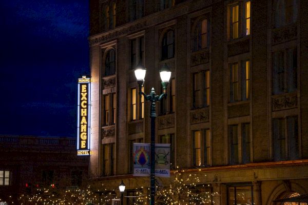 A nighttime scene shows a building with illuminated windows and an 
