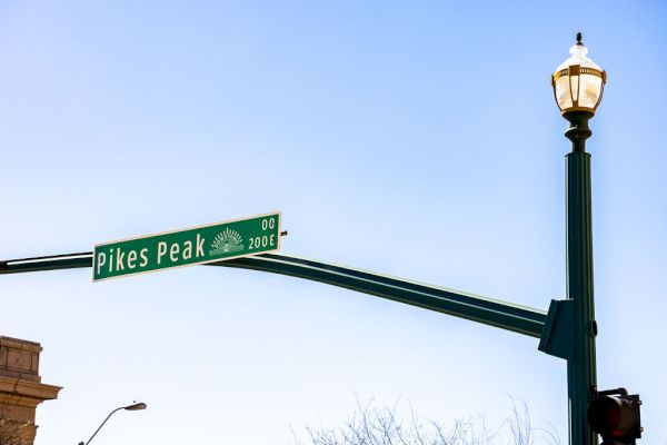 The image shows a green street sign for 