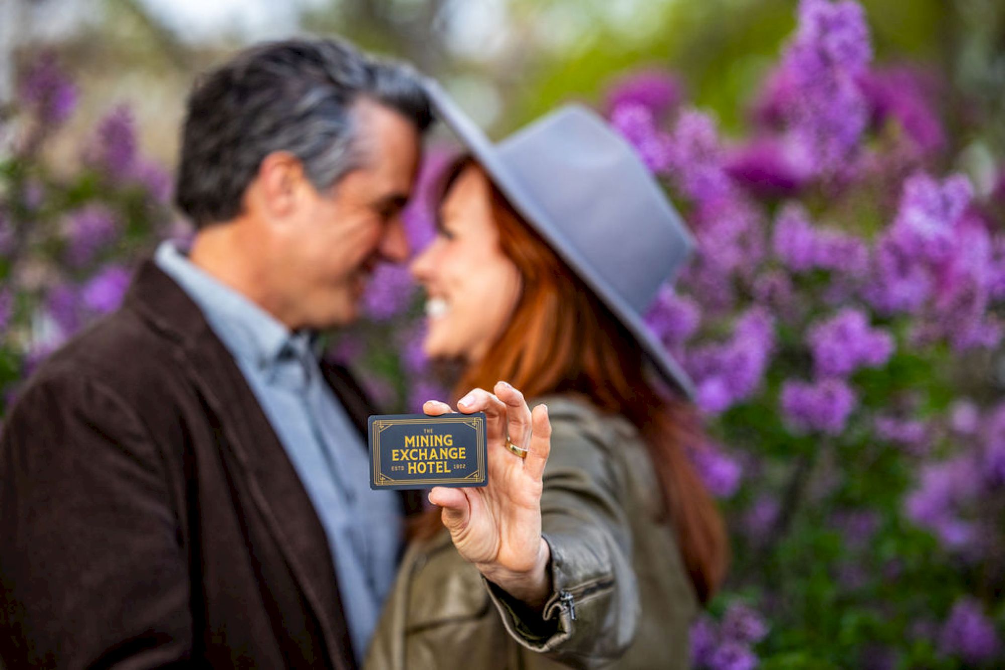 A couple is in focus while they hold a 