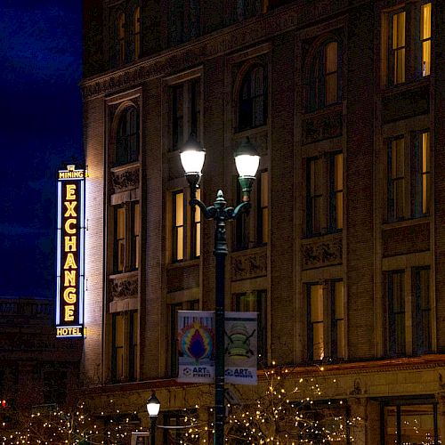 The image shows a building at night with a lit 